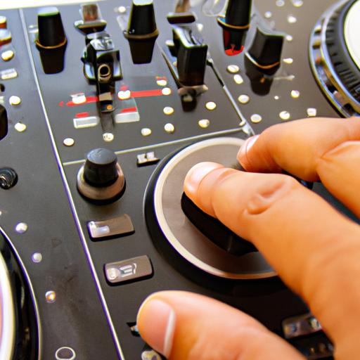 A DJ adjusting the sound levels on a rotary DJ mixer